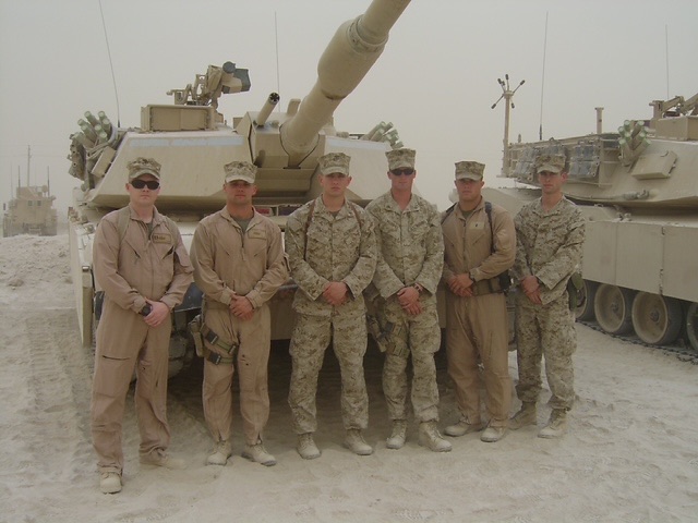 Naval Academy alumni in front of an M1A1 tank in Iraq